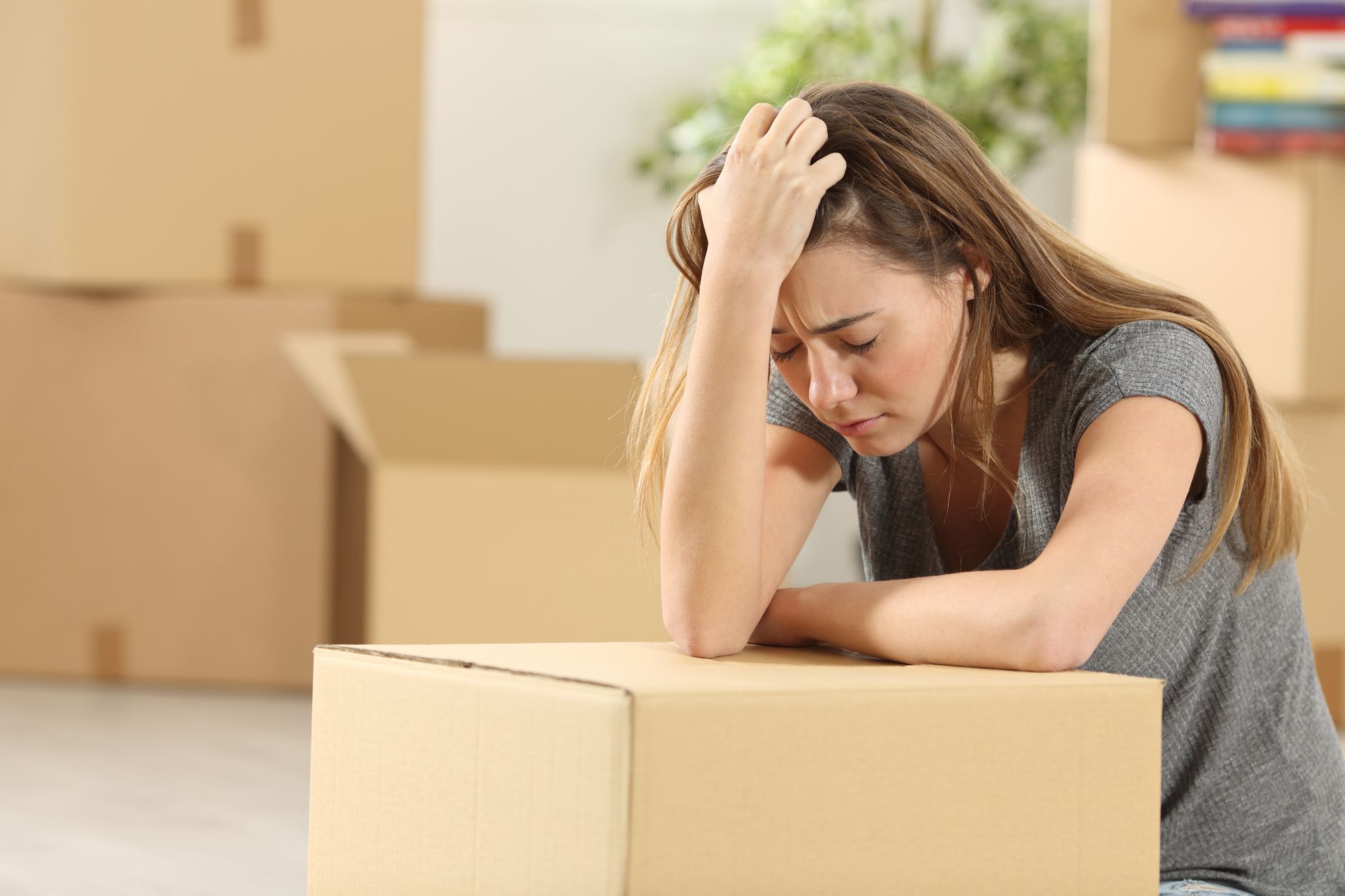 Sad woman with boxes